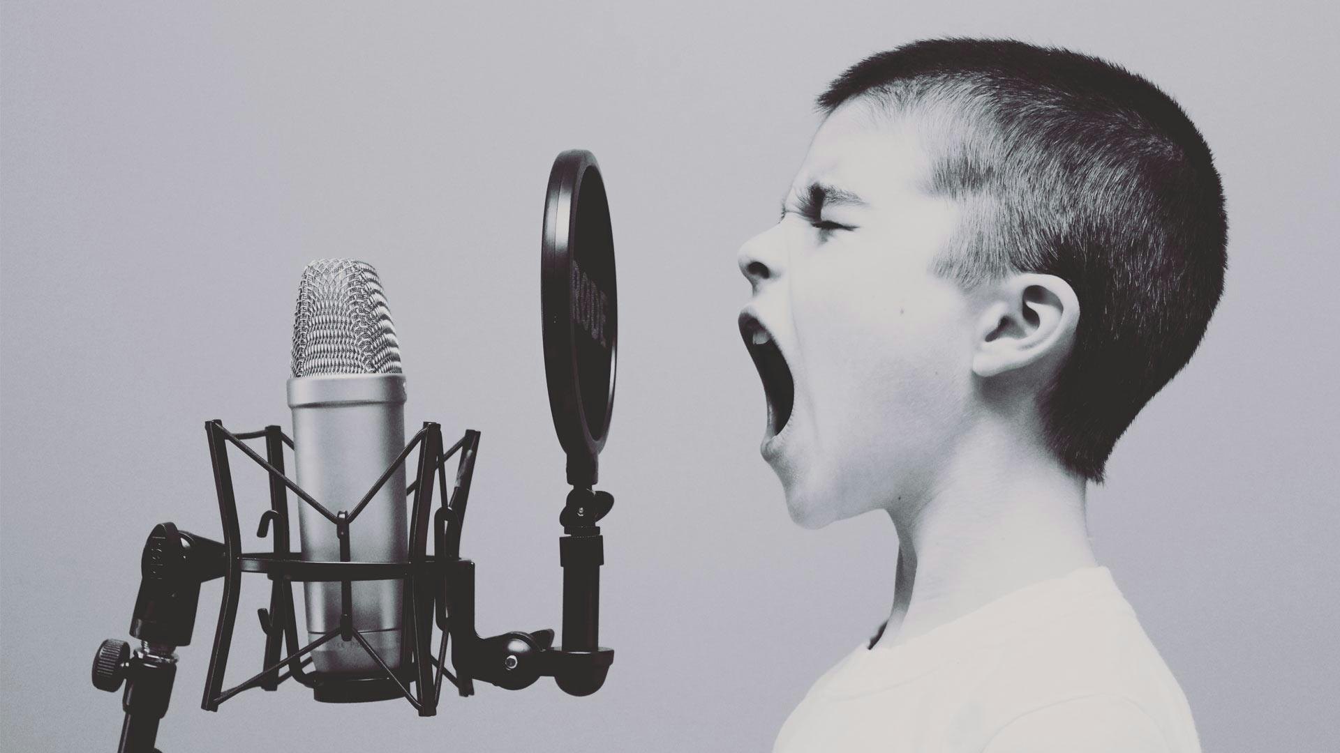 Boy Yelling into Microphone